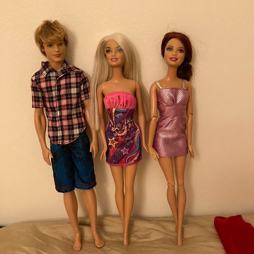 3 Mattel dolls- 2 Barbie dolls & Ken dressed in summer outfits.